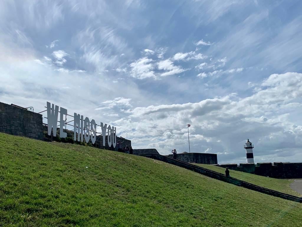 we miss you sign on castle field